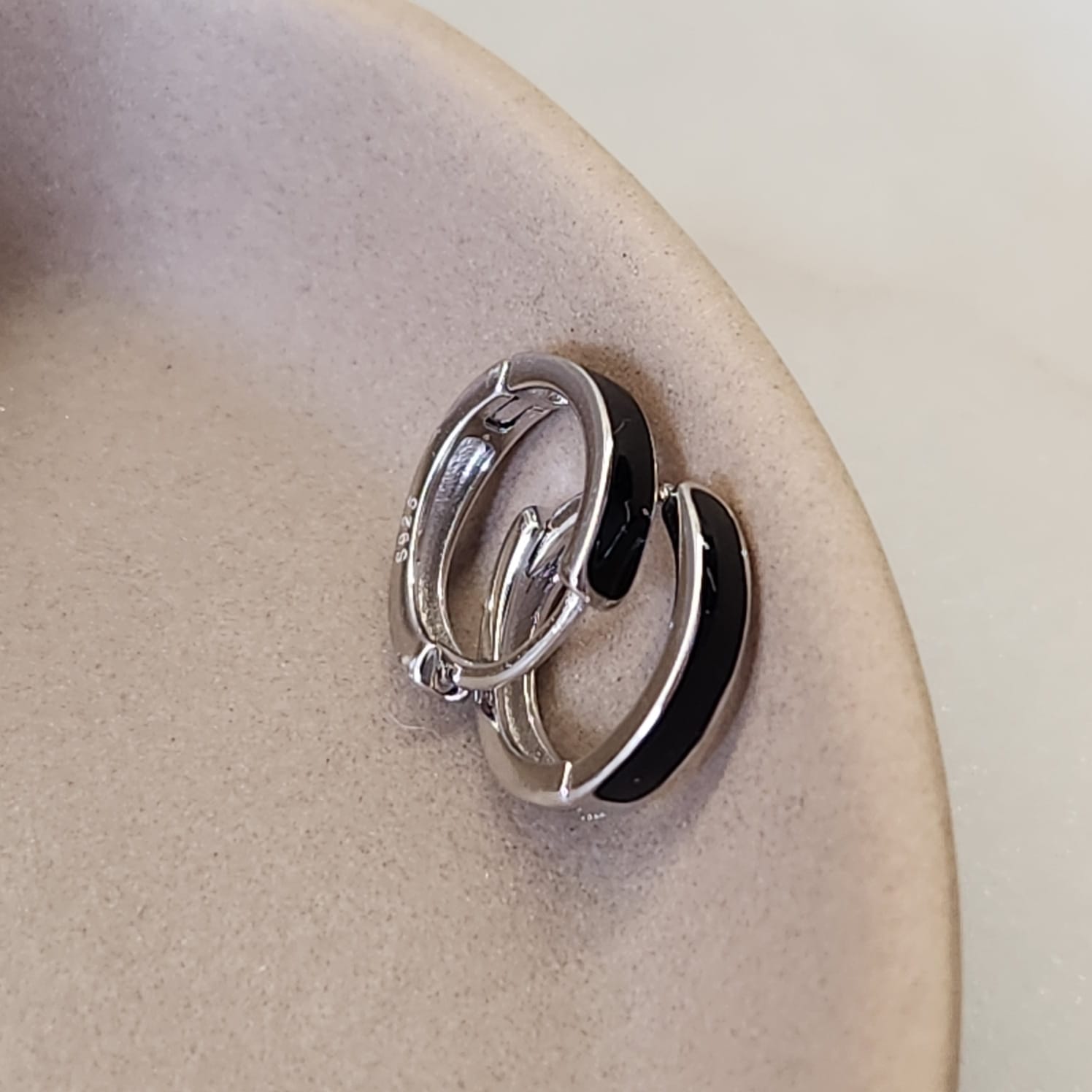 Black Inlay Huggie Earrings worn on ear contemporary minimal design