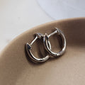 Minimal Huggie Earrings silver tone worn on ear everyday styling