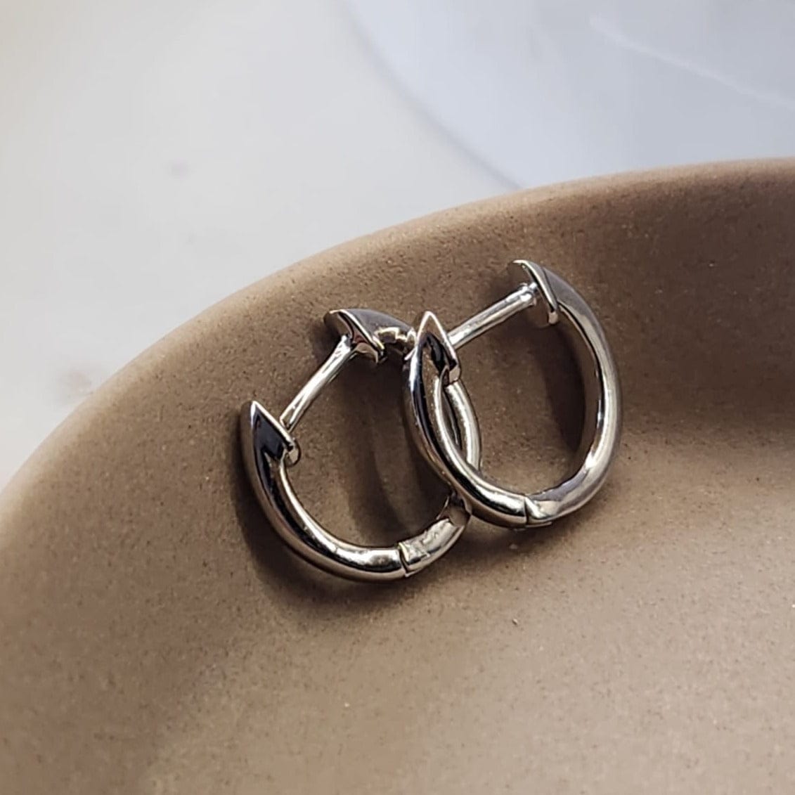 Minimal Huggie Earrings silver tone worn on ear everyday styling