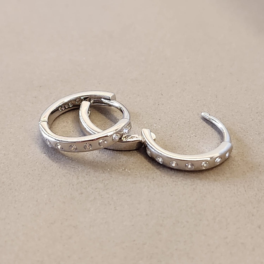 Fine and Yonder Earrings Silver Spaced Zircon Huggie Earrings