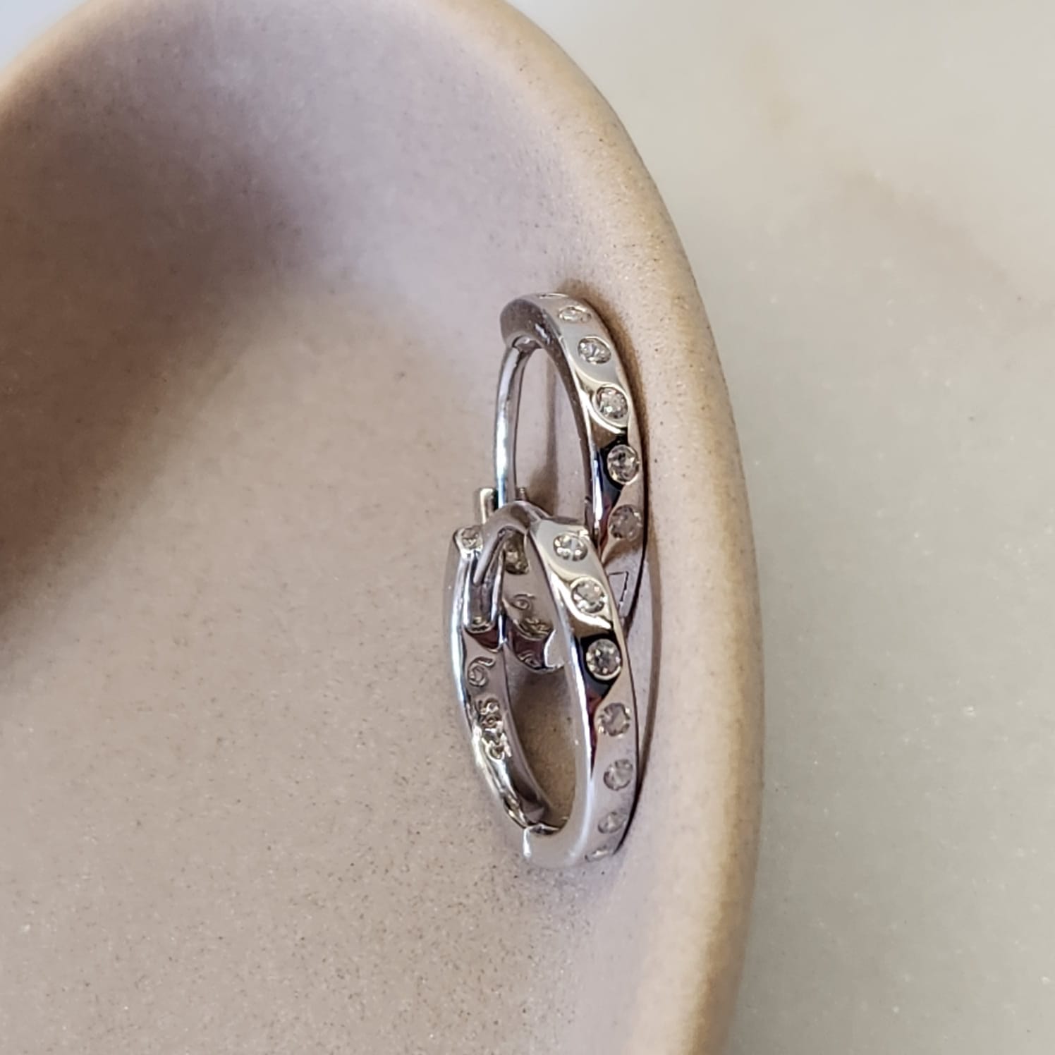 Spaced Zircon Huggie Earrings CZ stones spaced interval detail close up