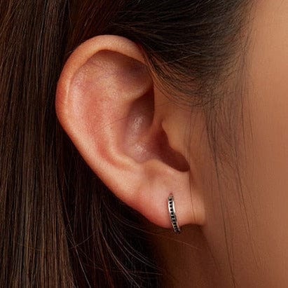 Black Zircon Stone Huggie Earrings black CZ stones close up detail